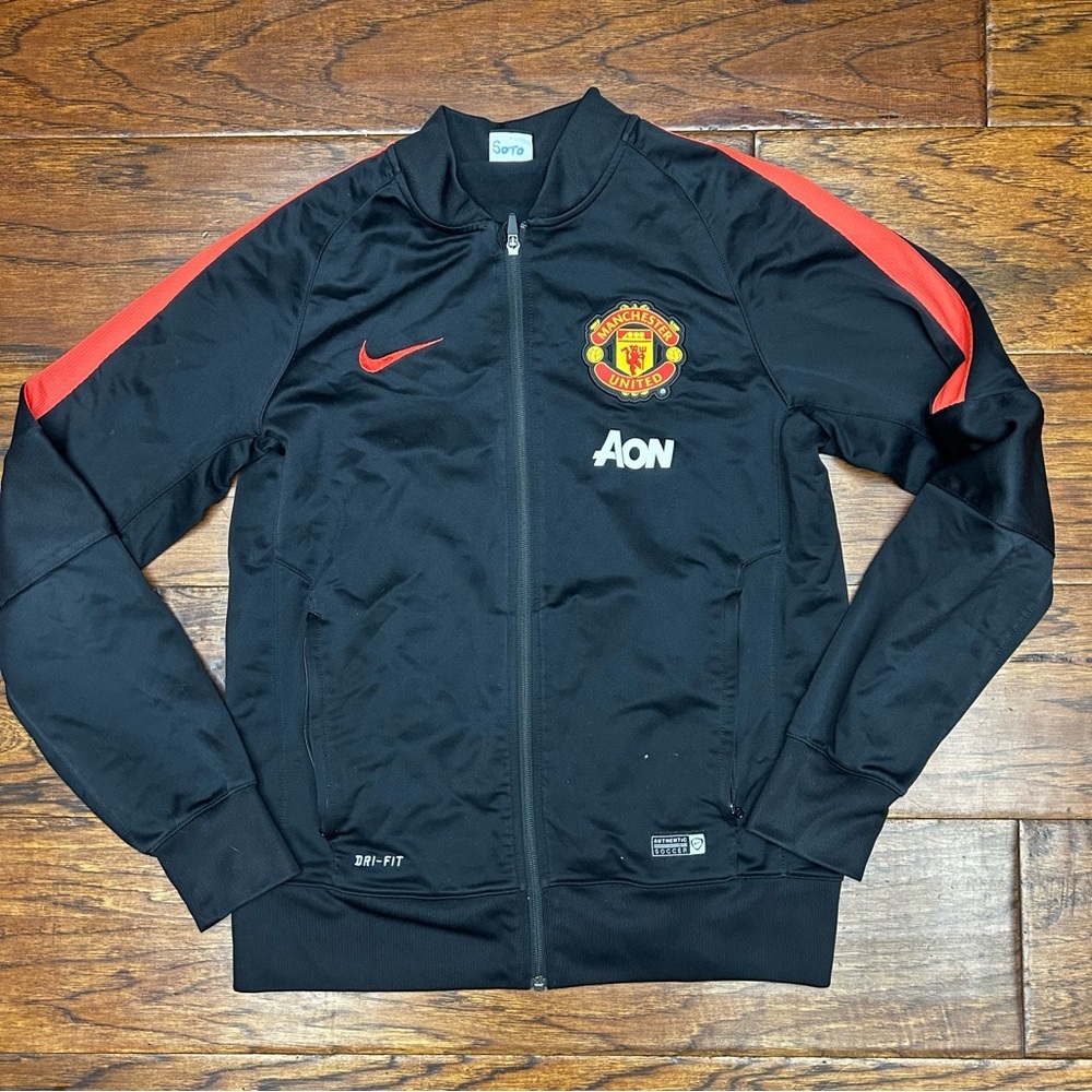 Nike Black Track Jacket with Red Shoulder Stripes and Manchester Crest